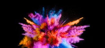 Photo of multicolored powders exploding.